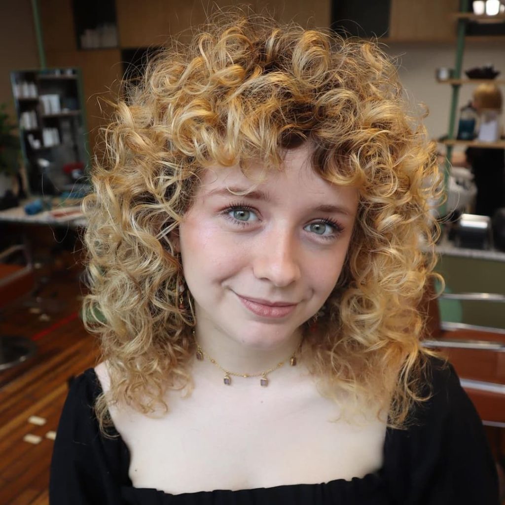30 Best Curly Wolf Cut Ideas to Showcase Your Beautiful Curls 10 Blonde Shaggy Wolf Cut on Curly Short Hair