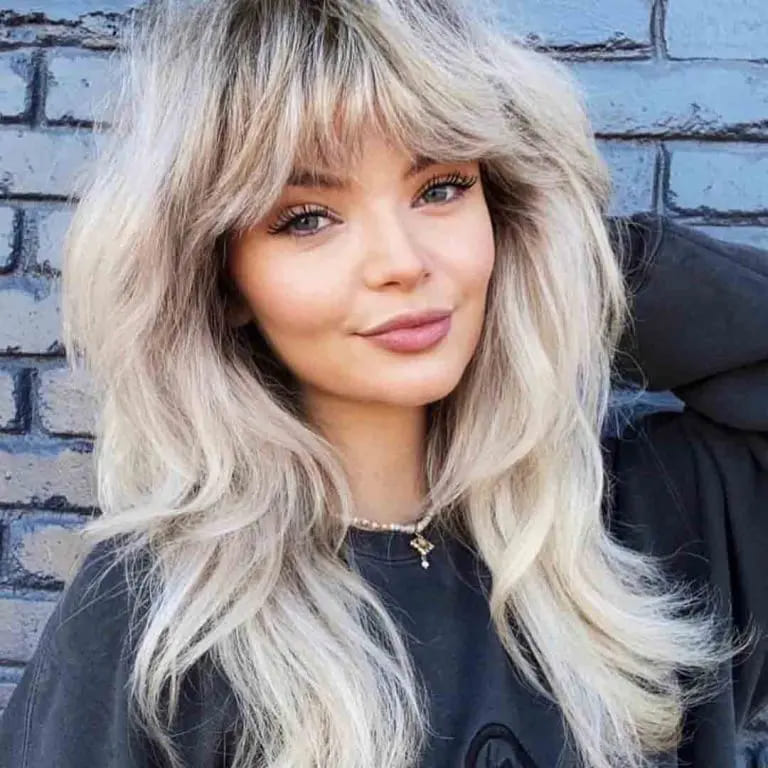 10 Blonde Wolf Cut Ideas For A Fresh Look 6 Long Wavy Blonde Wolf Cut With Curtain Bangs