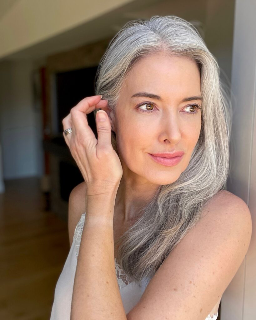 10 Hairstyles for Women Over 60 2 Soft Layered Long Gray Wavy Hair 819x1024 1