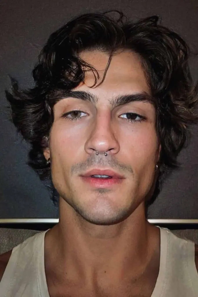 12 Flowy Haircut Ideas for Men 11 Tousled Curly Flow