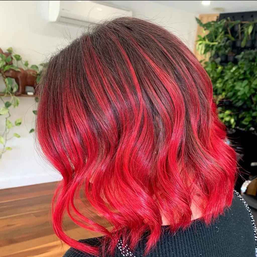 Medium Wavy Brown Hair With Cherry Bomb Highlights