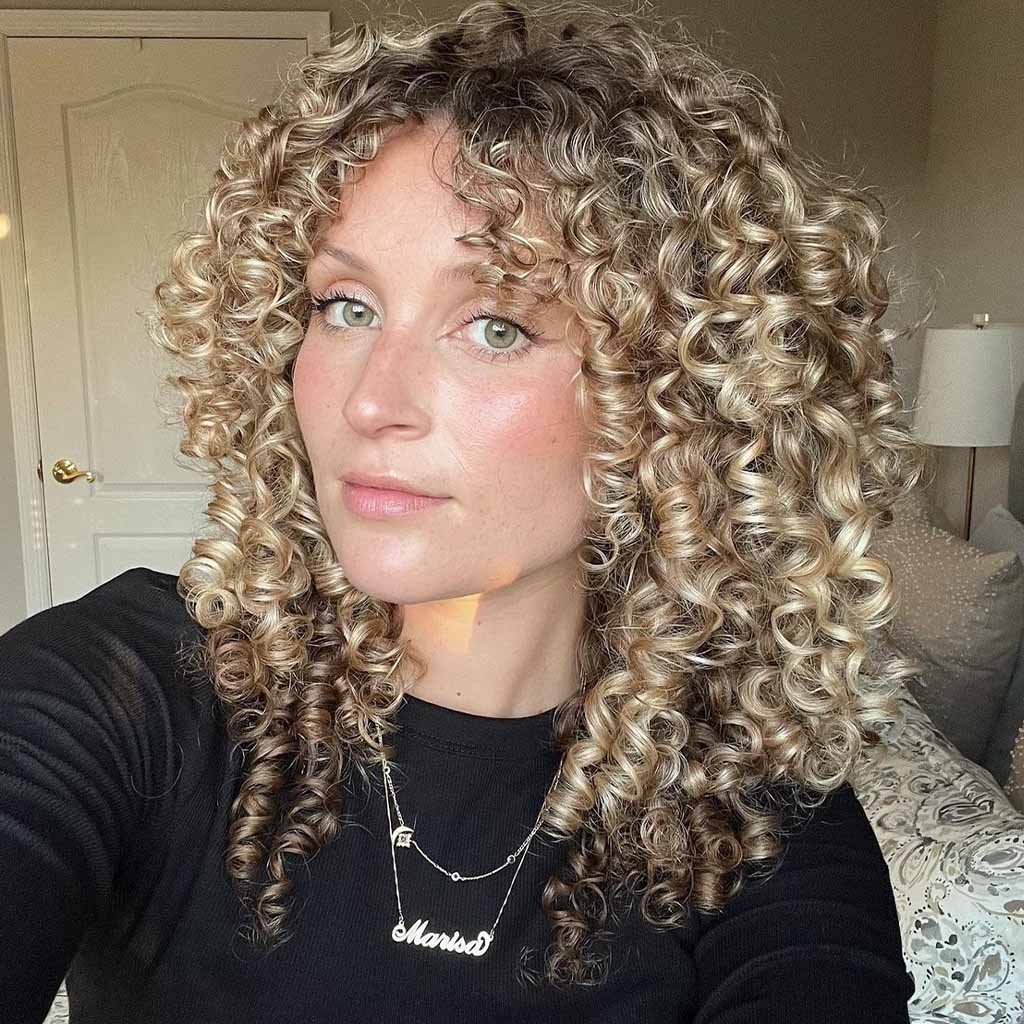20 Playful Curly Hair Ideas! 7 Blonde Spiral Curls With Curly Curtain Bangs and Brown Highlights