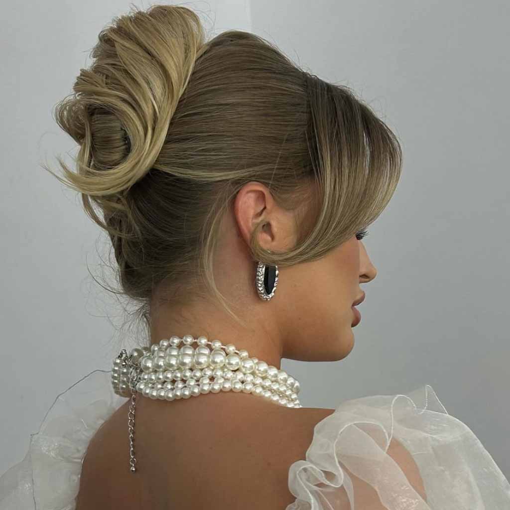 15 Stunning Bun Hairstyles for Elegance! 7 Top Bun With Side-Swept Bangs