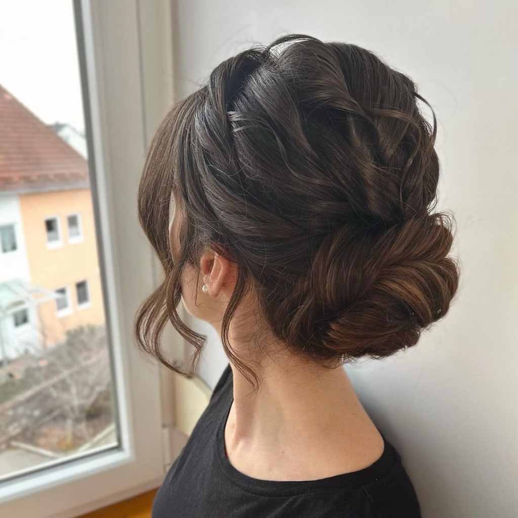 15 Stunning Bun Hairstyles for Elegance! 8 Twisted Nape Wavy Bun