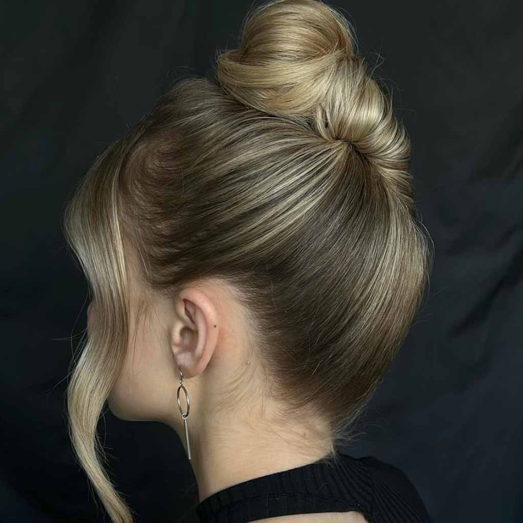 15 Stunning Bun Hairstyles for Elegance! 11 Topical Shell Top Bun With Wavy Tendrils