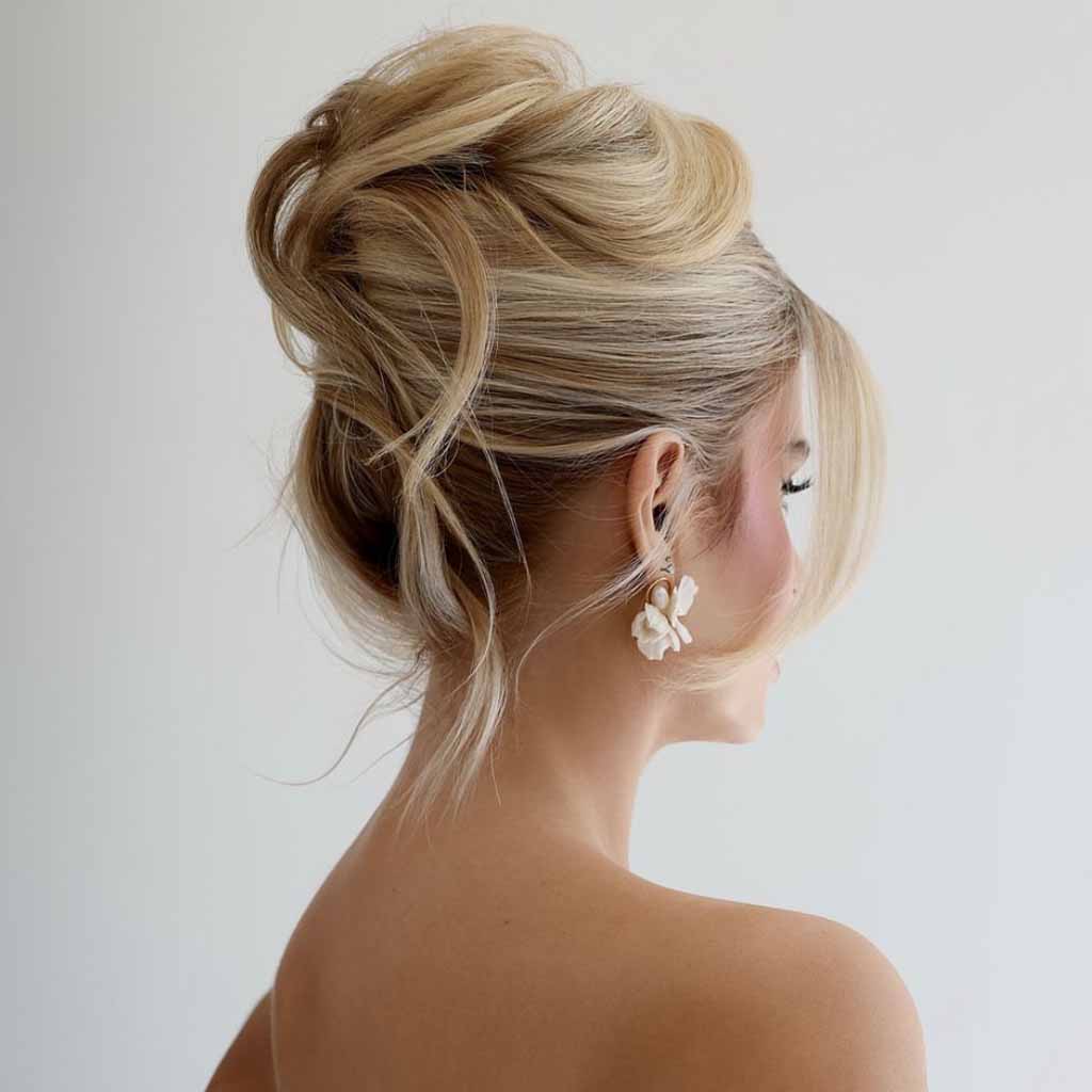 15 Stunning Bun Hairstyles for Elegance! 12 Blonde Messy Bun Updo With Face-Framing Tendrils