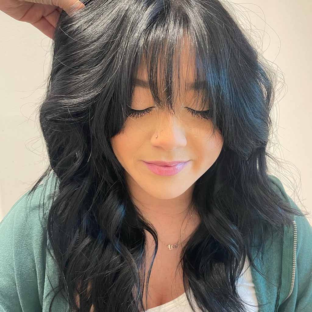 Dark Hair and a Textured Haircut With Wispy Bangs