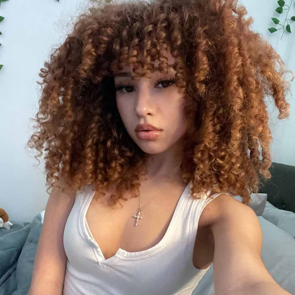 20 Playful Curly Hair Ideas! 13 Medium Copper Coiled Hair With Extended Curly Bangs
