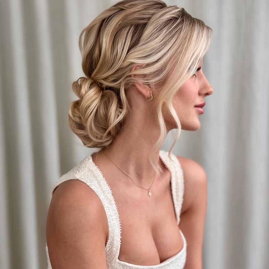 15 Stunning Bun Hairstyles for Elegance! 14 Blonde Wavy Bridal Low Bun