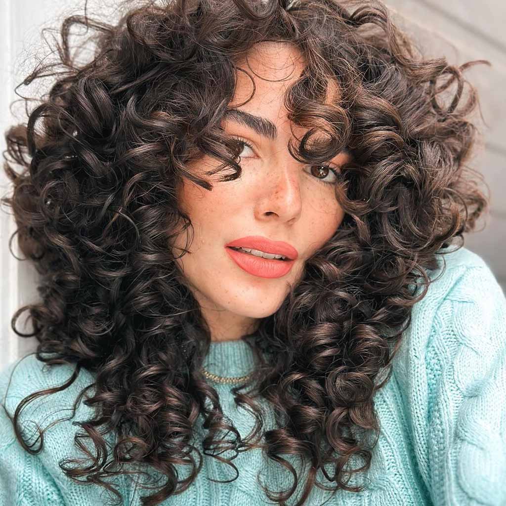20 Playful Curly Hair Ideas! 18 Tousled Layered Curly Medium Hair With Brown Highlights