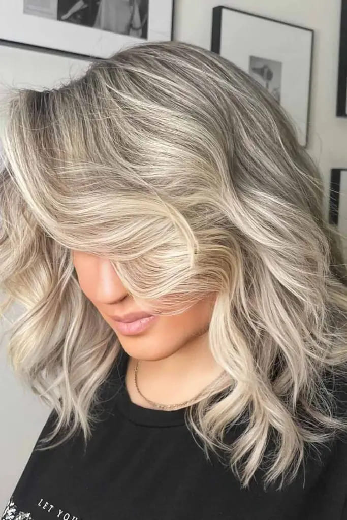 12 Lowlights for Blonde Hair 11 Voluminous Blonde Waves with Subtle Low Lights
